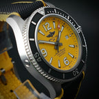 Breitling Superocean A17367 44mm Yellow Dial Steel Bracelet — wrist shot on stainless steel bracelet