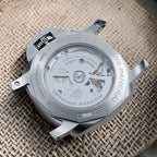 Panerai PAM01033 sapphire exhibition caseback showing the P.9011 automatic movement and power-reserve indicator