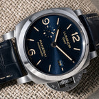 Panerai Luminor GMT PAM01033 blue sandwich dial close-up with date, small seconds and stainless steel crown guard