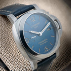 Panerai Luminor GMT PAM01033 oblique dial view showing blue finish, luminous markers and brushed steel case