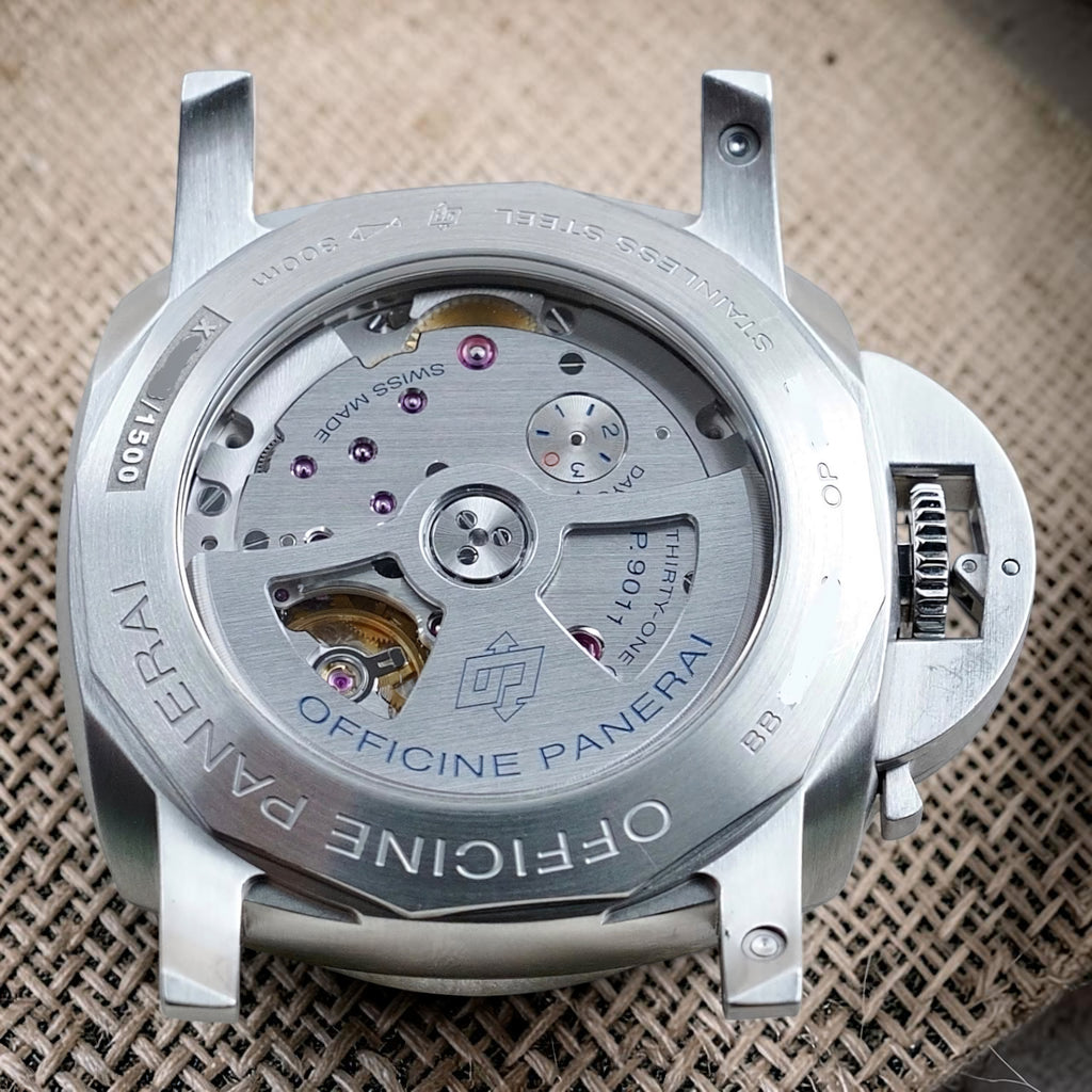 Panerai Luminor GMT PAM01033 caseback close-up with P.9011 rotor, movement bridges and three-day power-reserve display