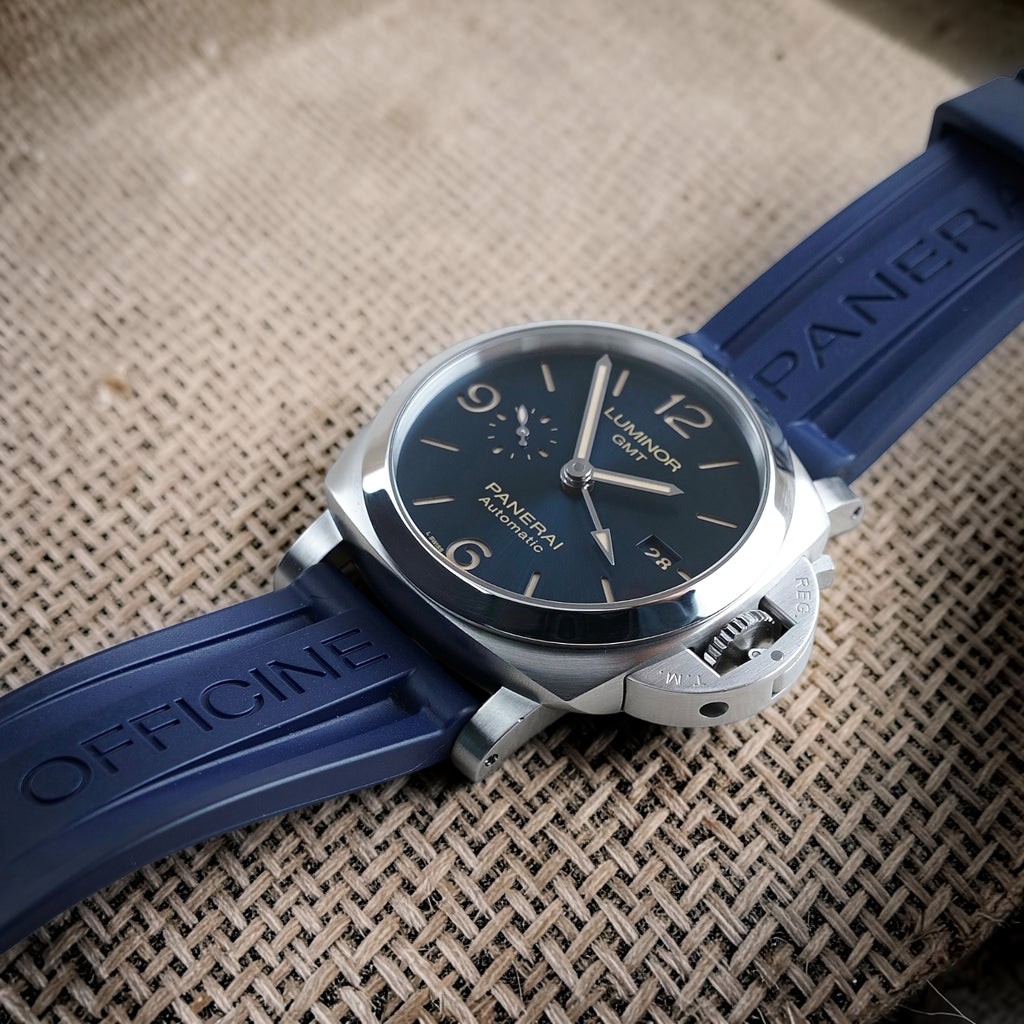 Panerai Luminor GMT PAM01033 blue dial watch fitted with the blue Officine Panerai strap