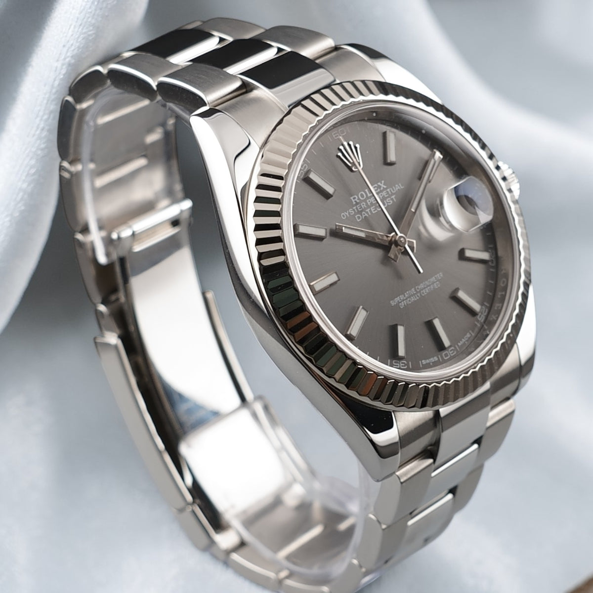 Angled view of Rolex Datejust 41 126334 with slate dial, date magnifier and stainless steel Oyster bracelet.