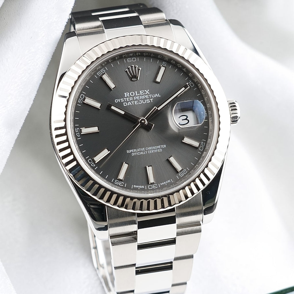 Front view of Rolex Datejust 41 126334 with slate stick dial, fluted bezel and Oyster bracelet on white fabric.