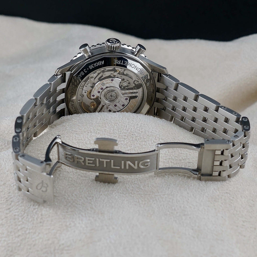 Wrist Flex Timepieces Breitling Navitimer AB0138 watch showing the exhibition caseback and stainless steel bracelet.