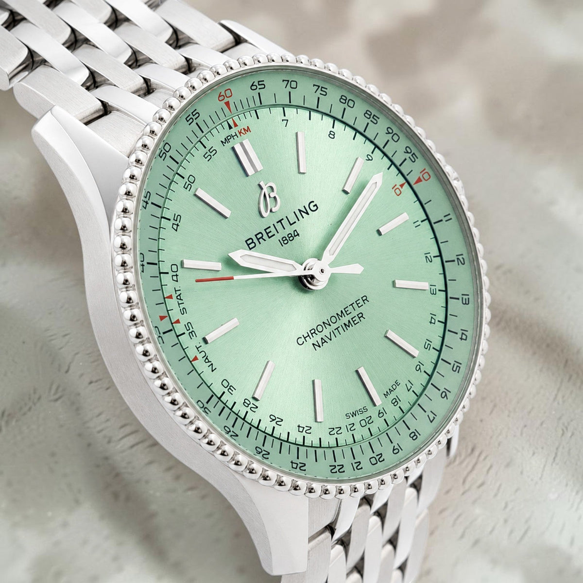 Wrist Flex Timepieces Breitling Navitimer Automatic 36 watch with a mint green dial and stainless steel bracelet.