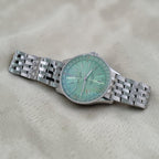 Wrist Flex Timepieces Breitling Navitimer Automatic 36 watch with a mint green dial and stainless steel bracelet.