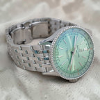 Wrist Flex Timepieces Breitling Navitimer Automatic 36 watch with a mint green dial and stainless steel bracelet.