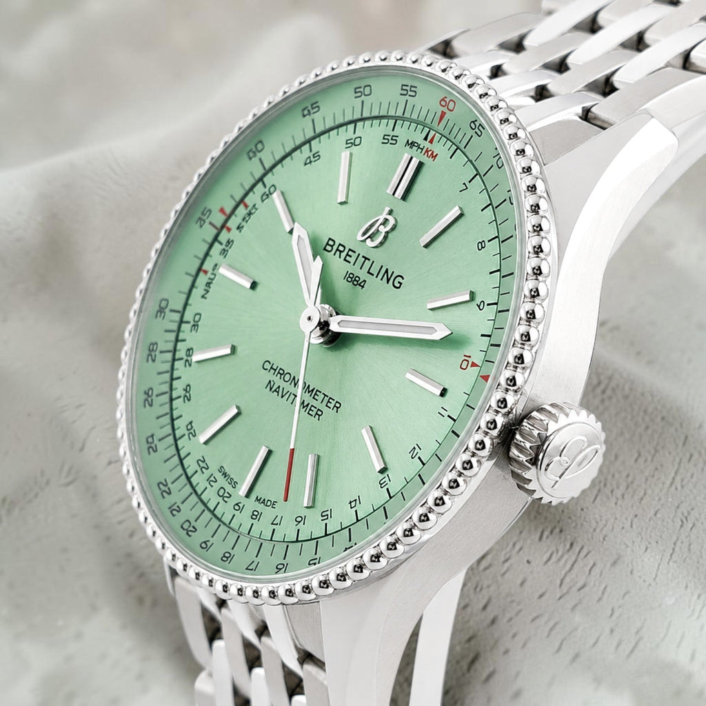 Wrist Flex Timepieces Breitling Navitimer Automatic 36 watch with a mint green dial and stainless steel beaded bezel.