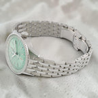 Wrist Flex Timepieces Breitling Navitimer Automatic 36 watch with a mint green dial and stainless steel bracelet.