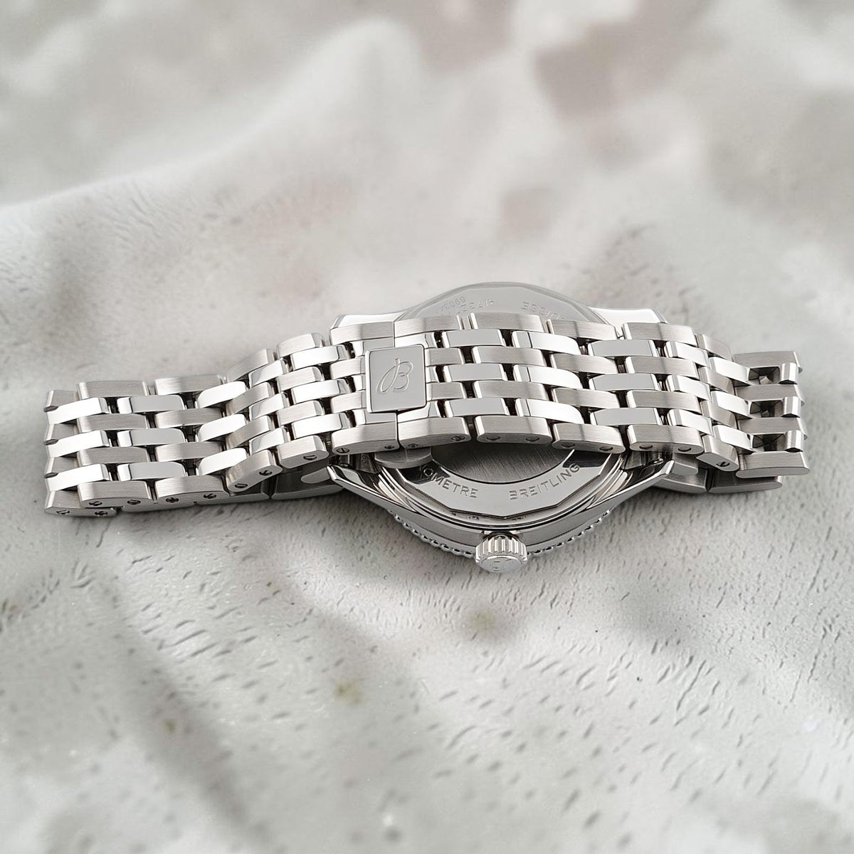 Wrist Flex Timepieces Breitling Navitimer 36 watch showing the stainless steel bracelet and case back detail