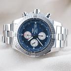 Wrist Flex Timepieces Breitling Super Avenger 48mm chronograph watch with blue dial and stainless steel bracelet.
