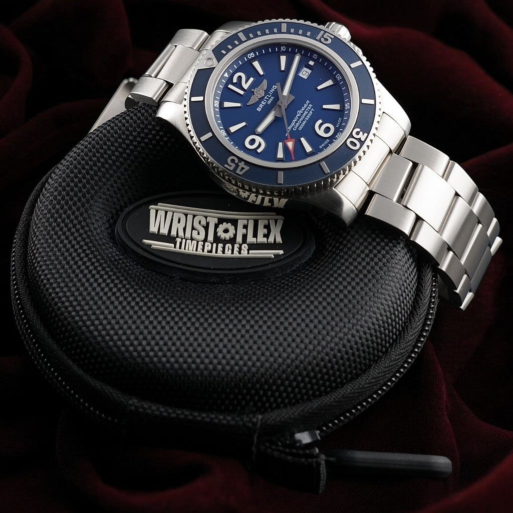 Breitling Superocean A17367 watch with blue dial and steel bracelet resting on a Wrist Flex Timepieces travel case.
