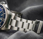 Wrist Flex Timepieces Breitling Superocean 44mm watch with a blue dial and brushed stainless steel bracelet
