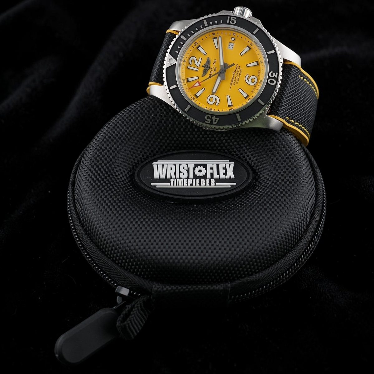 Wrist Flex Timepieces Breitling Superocean 44mm watch with a vibrant yellow dial and black strap resting on a travel case