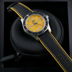 Wrist Flex Timepieces Breitling Superocean 44mm watch with a vibrant yellow dial and black rubber strap