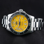Wrist Flex Timepieces Breitling Superocean 44mm watch with a vibrant yellow dial and stainless steel bracelet