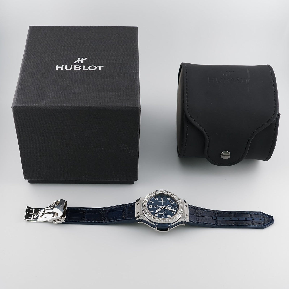 Wrist Flex Timepieces Hublot Big Bang 41mm watch with blue dial, diamond bezel, and alligator strap, including box.