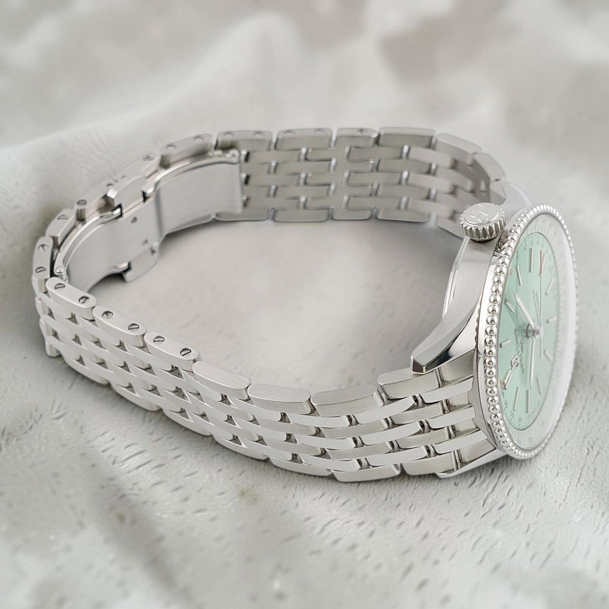 Wrist Flex Timepieces Breitling Navitimer Automatic 36 watch with a mint green dial and stainless steel bracelet
