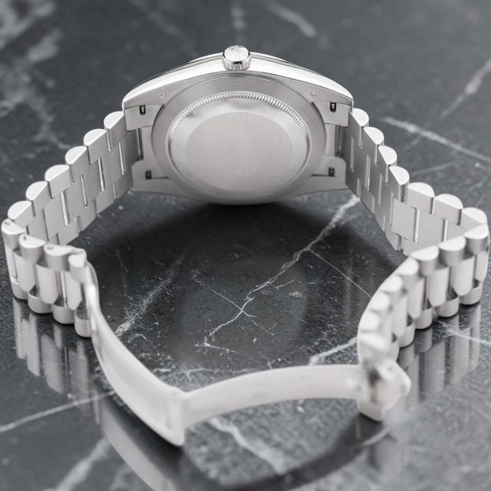 Wrist Flex Timepieces Rolex Day-Date watch showing the back of the silver President bracelet and case on marble