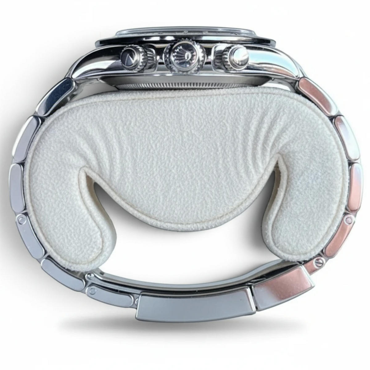 Wrist Flex Timepieces Rolex Daytona 116500LN stainless steel watch case and Oyster bracelet on a white display cushion